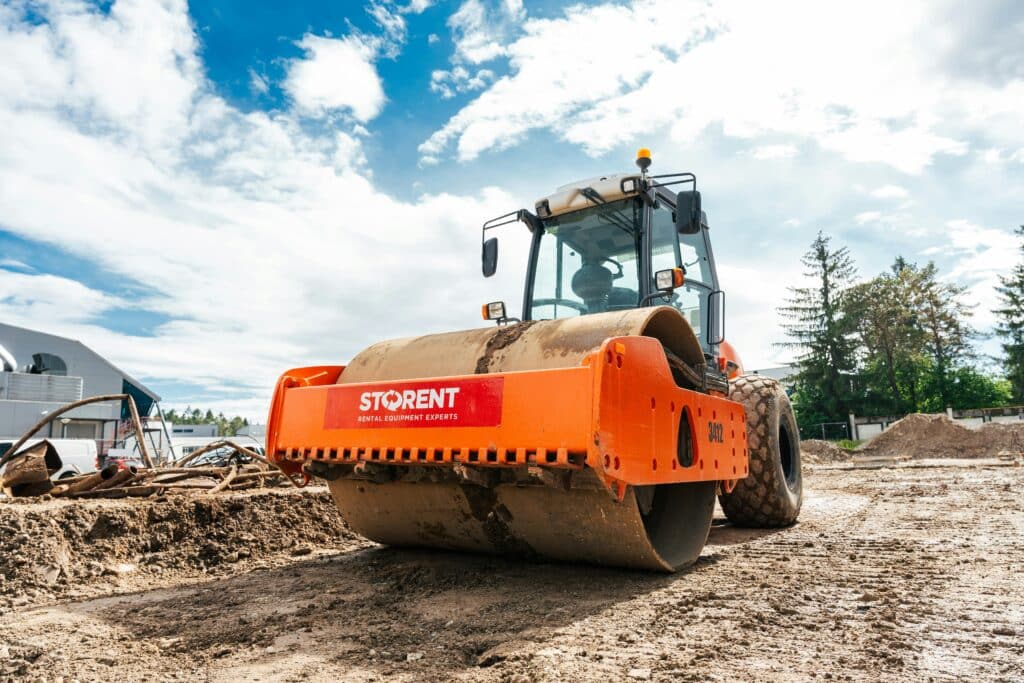 Large vibratory roller compactor on a sunny construction site in Keila, Estonia.
